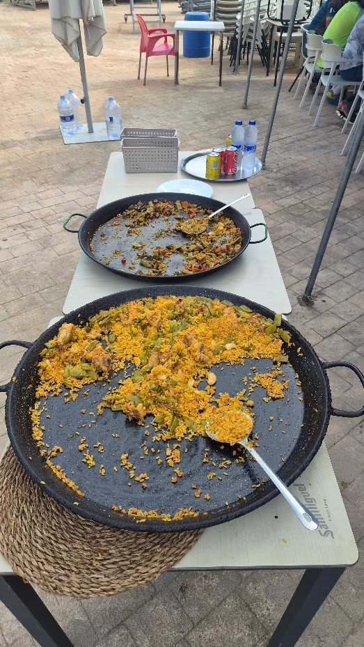Large paella pans cooking for a cricket team meal