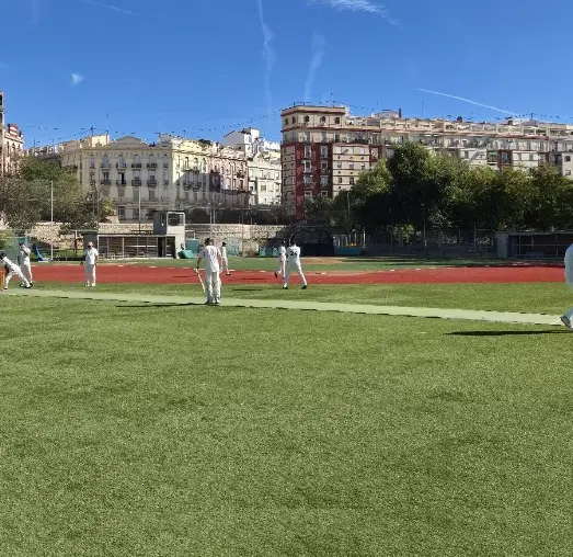 Cricket match in progress at a Valencia sports ground
